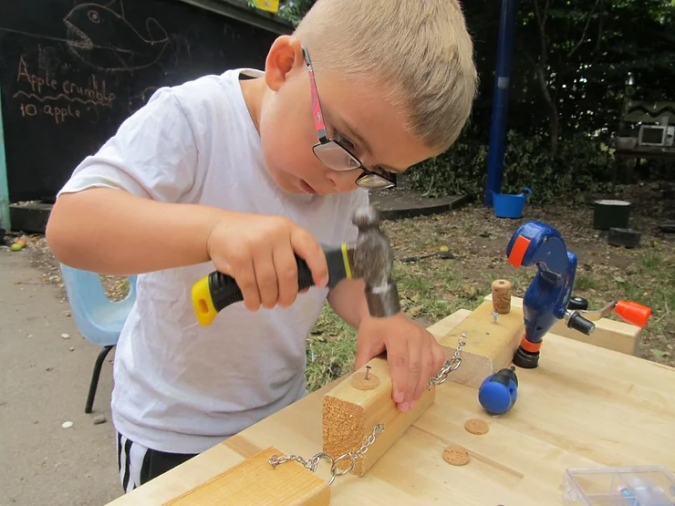 Image of a young boy using a hammer