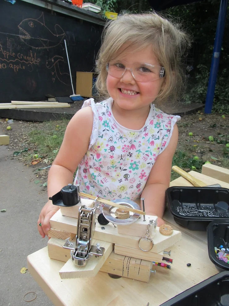 Image of a young girl using woodworking equipment